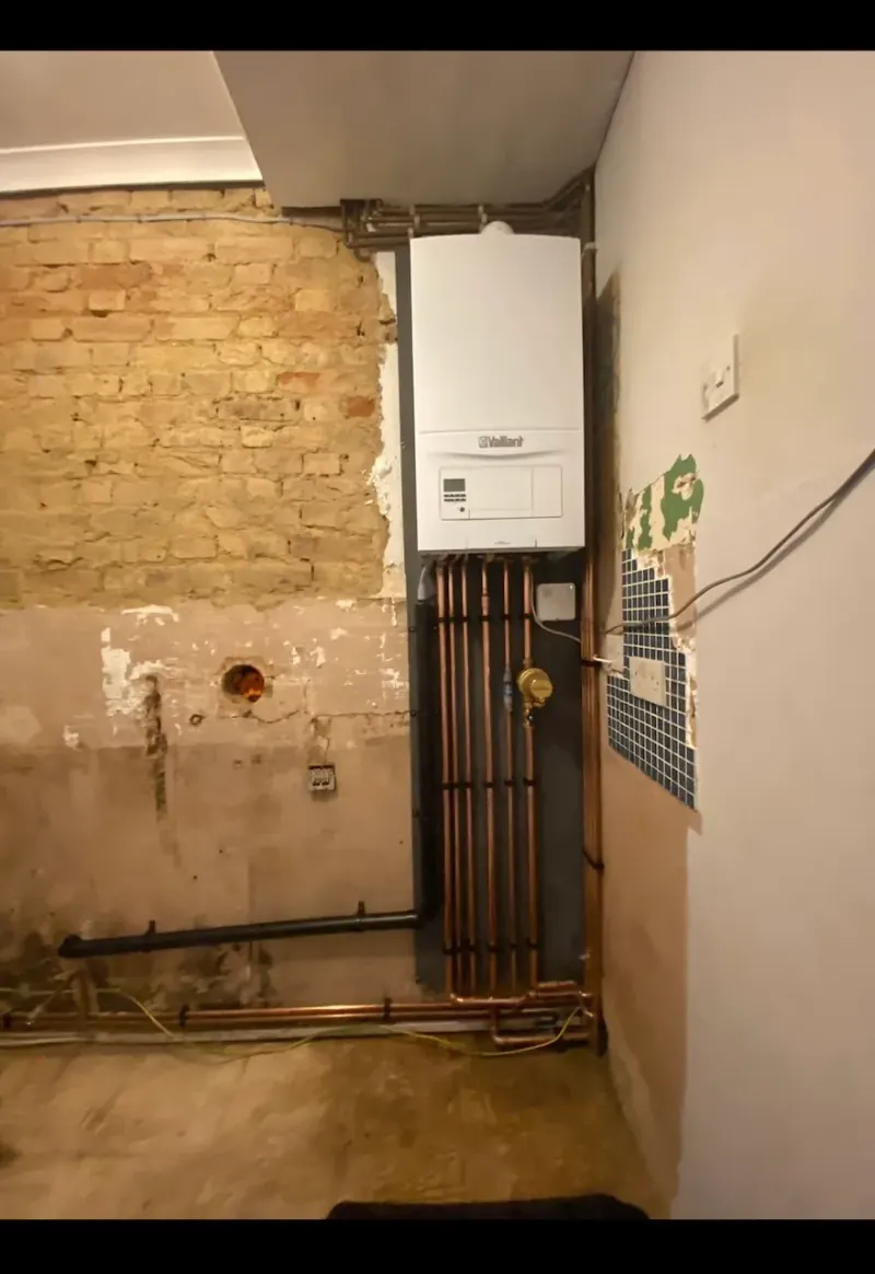 Bare brick room with wall plate and flue hole ready for boiler