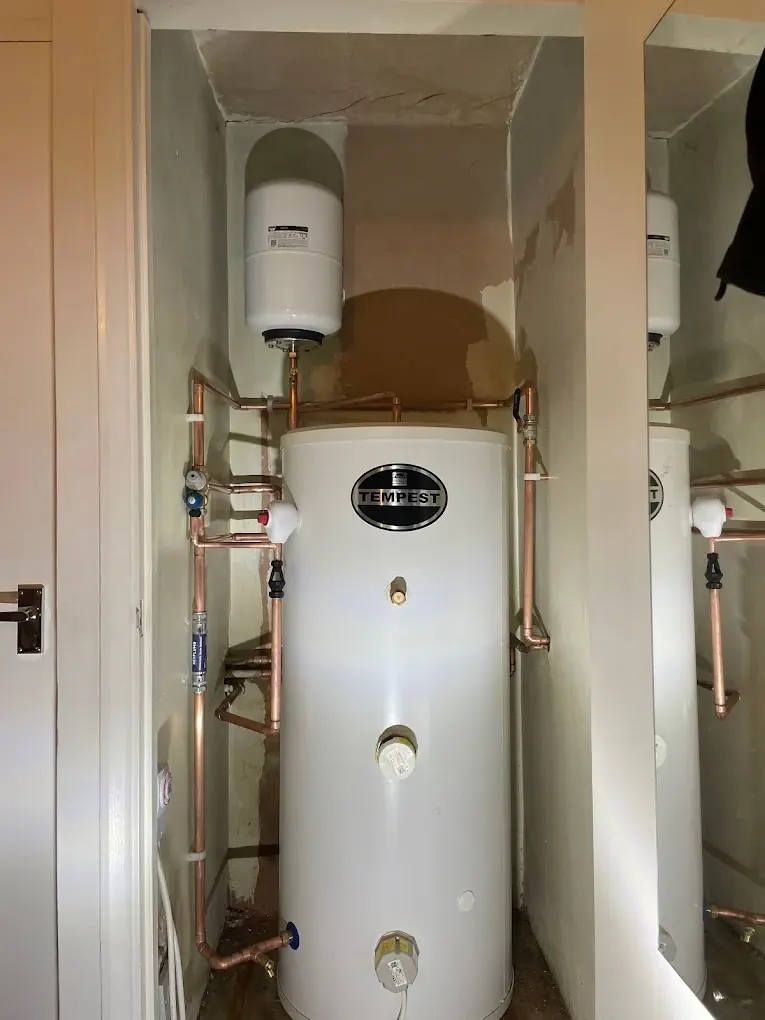 Tempest unvented cylinder fitted into an airing cupboard with expansion vessel above