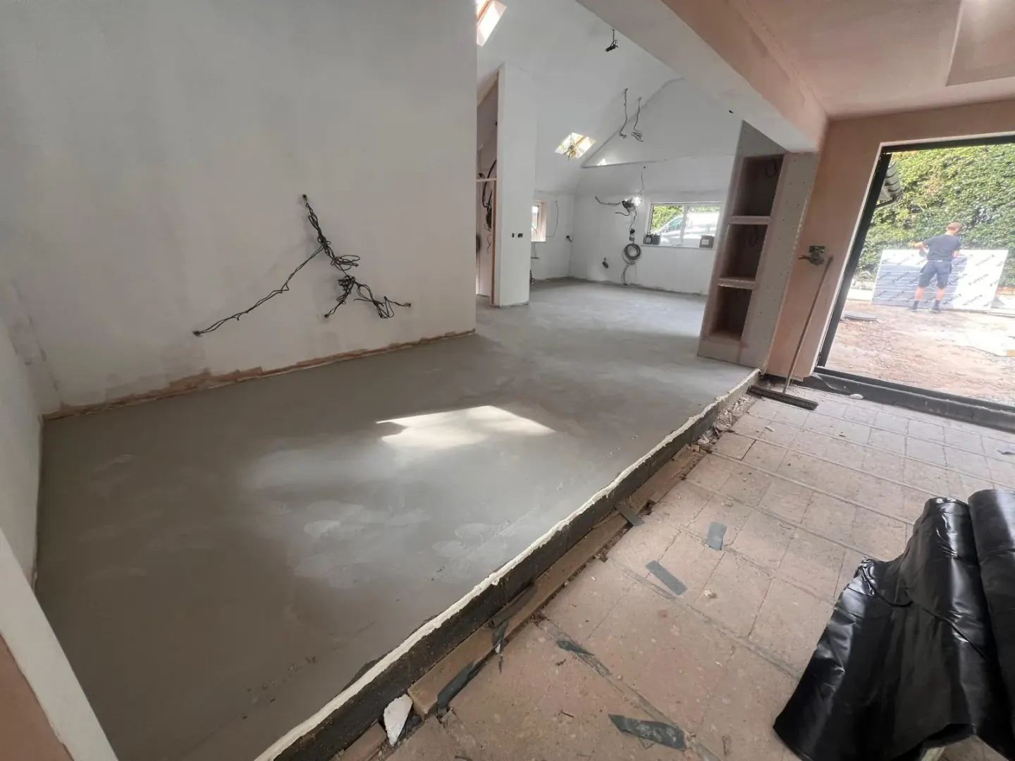 Liquid screed poured over the underfloor heating pipework